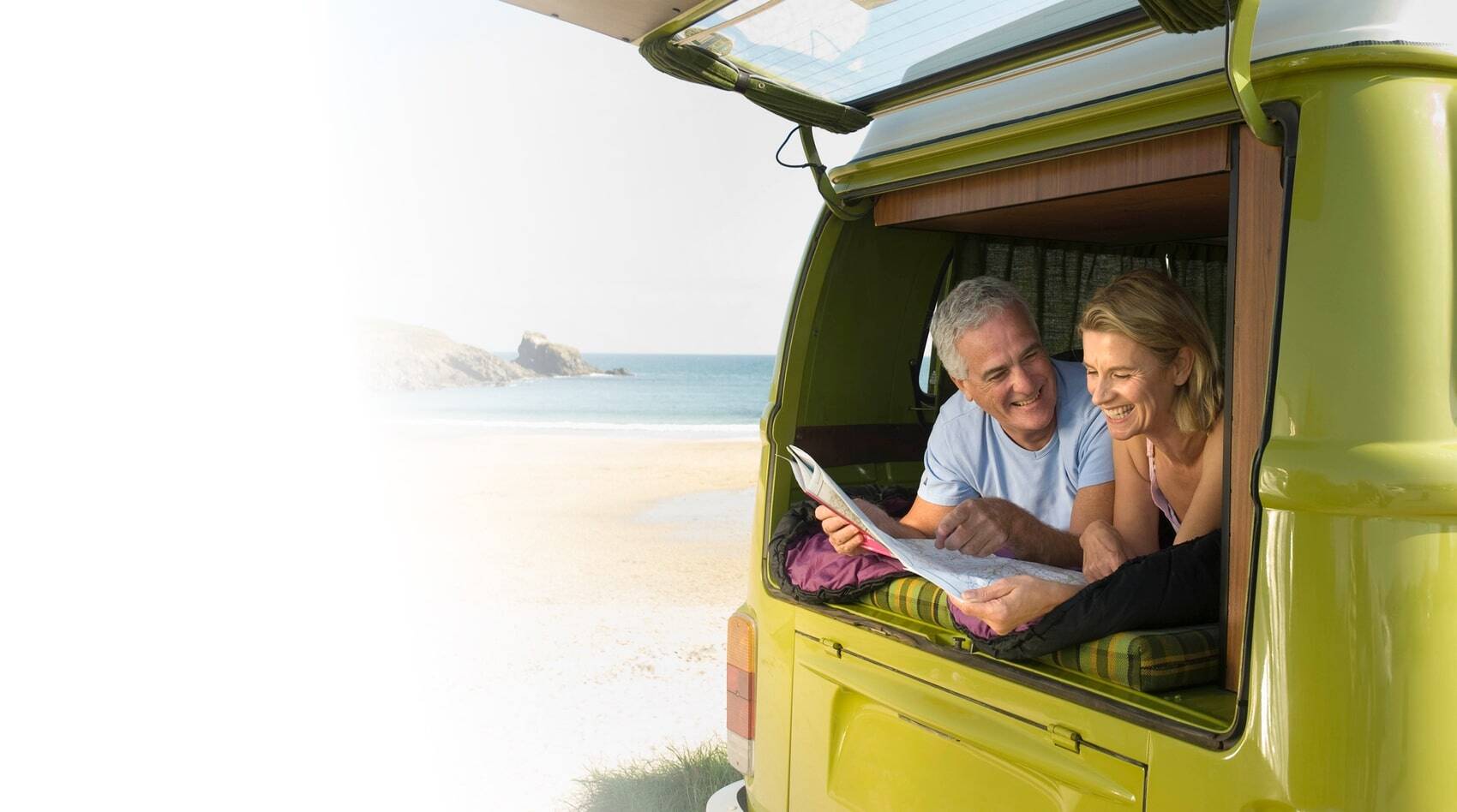 Couple looking at a map in the back of a van