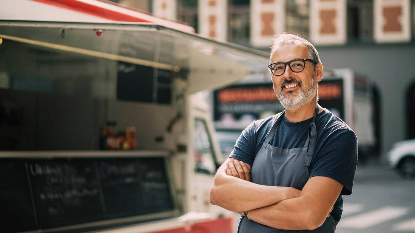 Man standing in front of a food truck