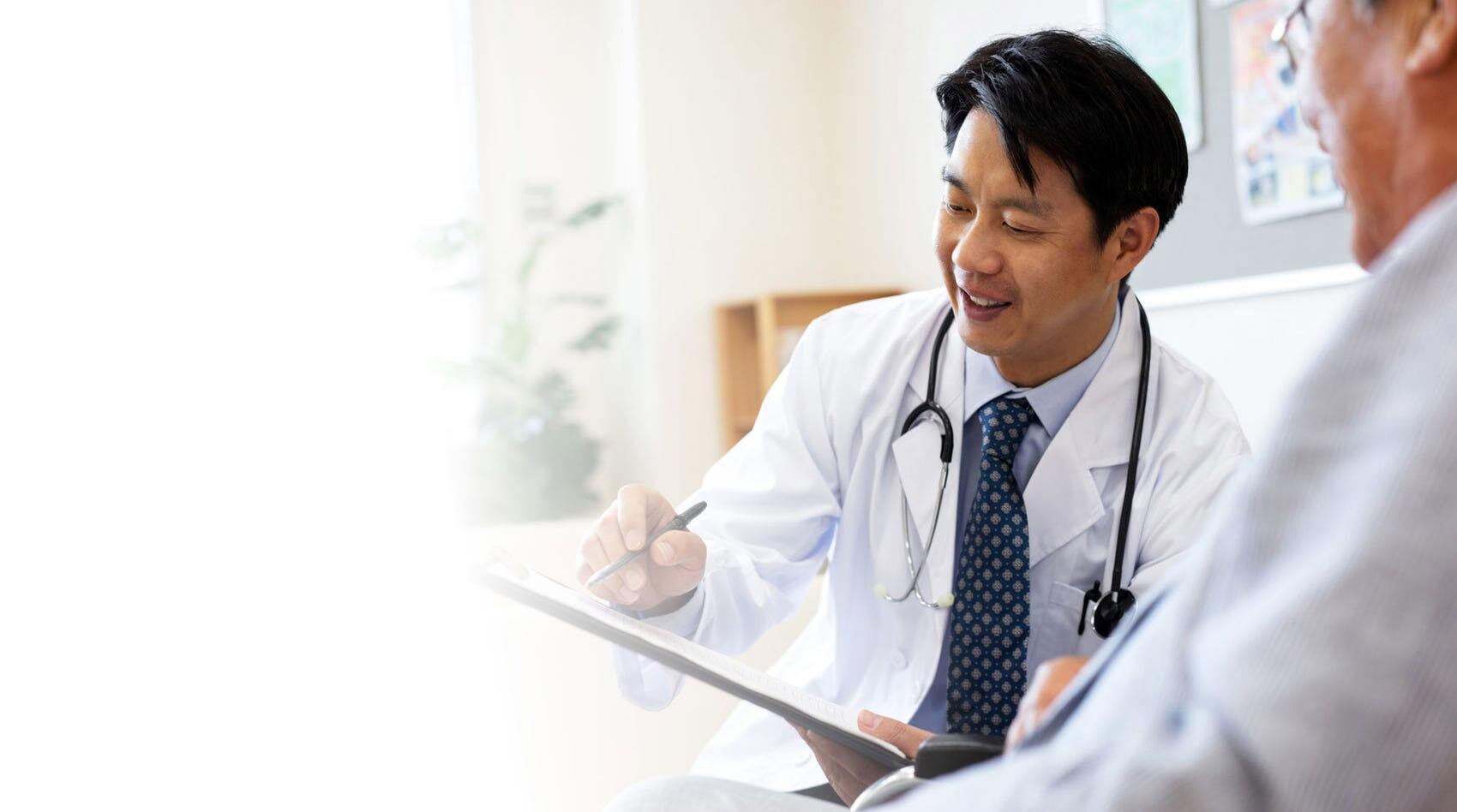 Doctor writing on a patient's chart